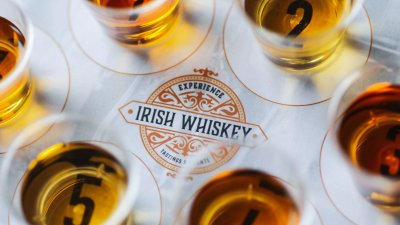 Experience Irish Whiskey on table with whiskey surrounding it 